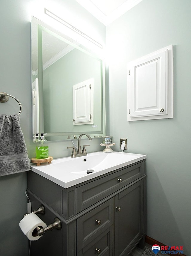 bathroom featuring vanity and ornamental molding