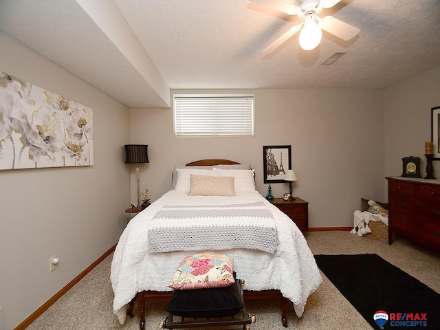 bedroom featuring carpet flooring, a textured ceiling, and ceiling fan