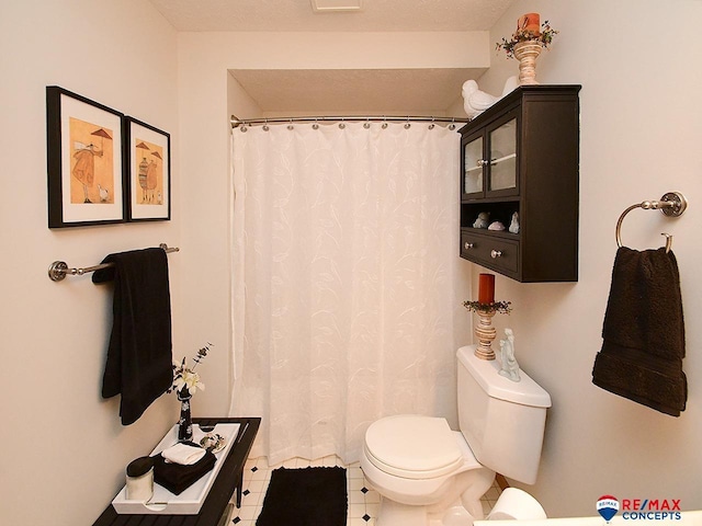 bathroom with tile patterned floors and toilet