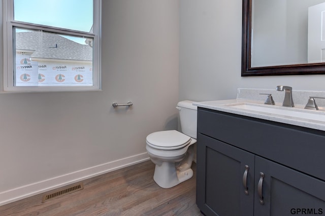 bathroom featuring hardwood / wood-style floors, vanity, and toilet