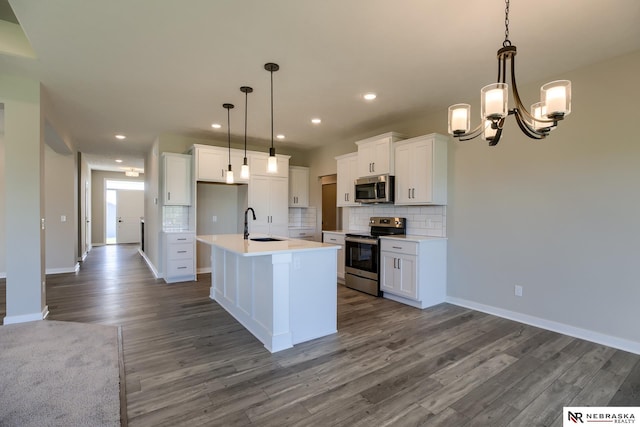 kitchen with white cabinets, an island with sink, and appliances with stainless steel finishes