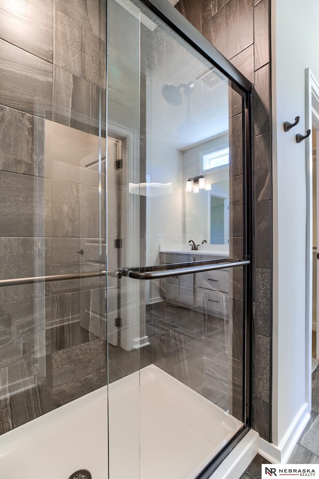 bathroom with a shower with shower door