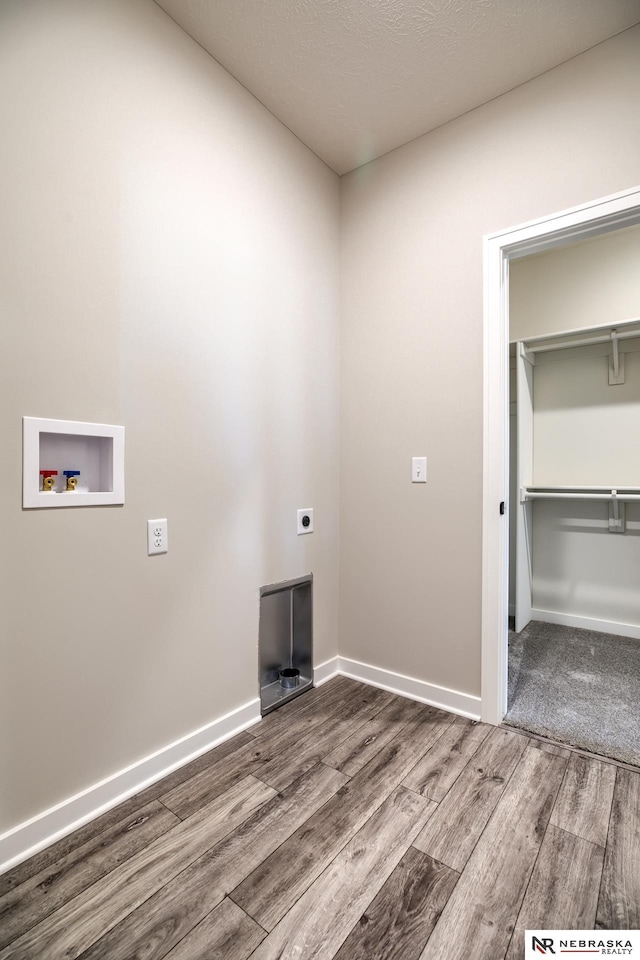 washroom featuring electric dryer hookup, hardwood / wood-style floors, and washer hookup