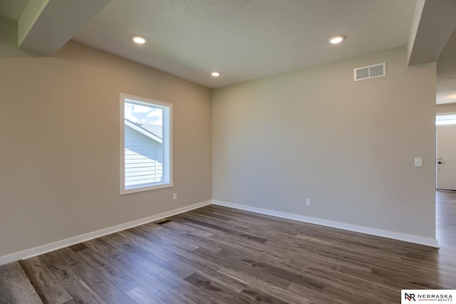 unfurnished room featuring dark hardwood / wood-style floors