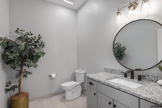 bathroom featuring tile patterned floors, vanity, and toilet