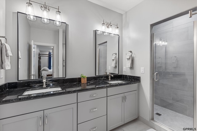 bathroom featuring vanity and an enclosed shower