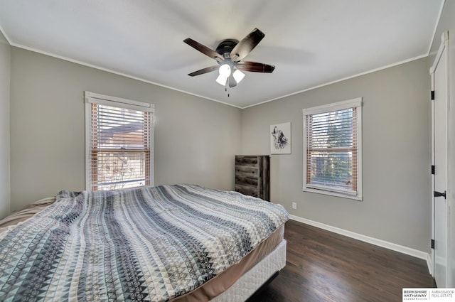 bedroom featuring ceiling fan, dark hardwood / wood-style flooring, and crown molding