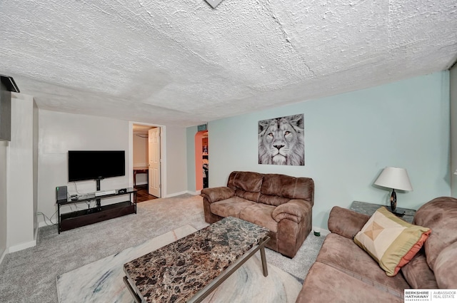 living room featuring light carpet and a textured ceiling