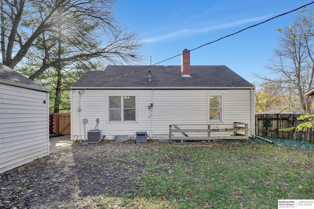 rear view of property featuring cooling unit and a deck