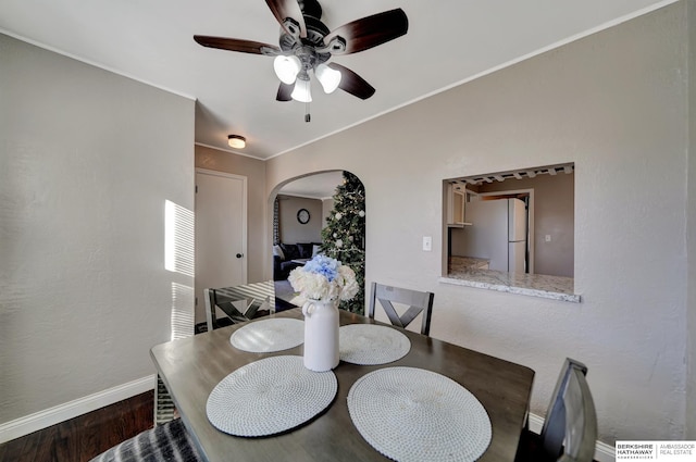 dining area featuring ceiling fan, dark hardwood / wood-style flooring, and ornamental molding