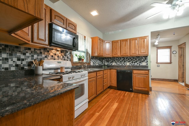 kitchen featuring black appliances, ceiling fan, a textured ceiling, and tasteful backsplash