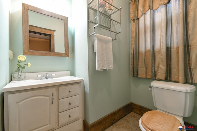 bathroom with tile patterned floors, vanity, and toilet