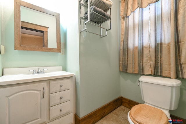 bathroom with tile patterned floors, vanity, and toilet