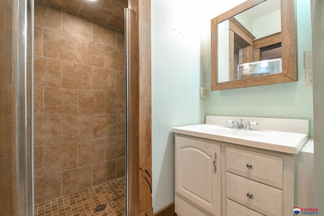 bathroom with vanity and a shower with door