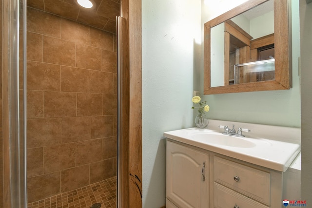 bathroom with vanity and a shower with shower door