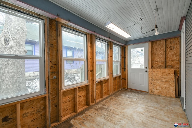 unfurnished sunroom featuring a wealth of natural light