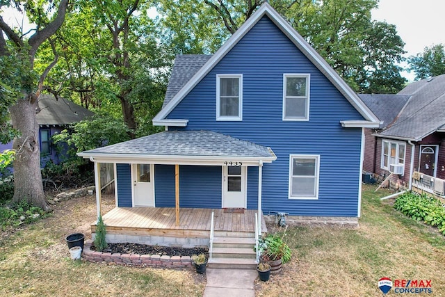 view of front of house featuring covered porch, a front lawn, and cooling unit