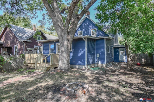 back of property featuring a fire pit