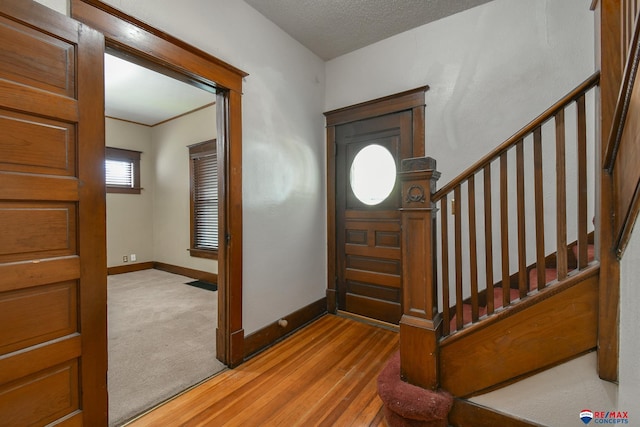 foyer featuring a textured ceiling and hardwood / wood-style flooring