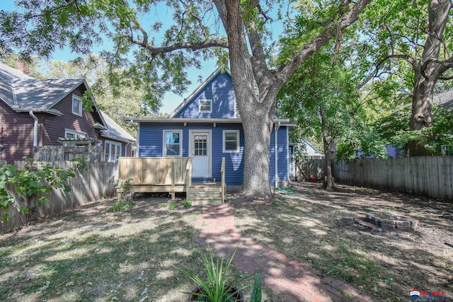 back of house featuring a yard and a wooden deck