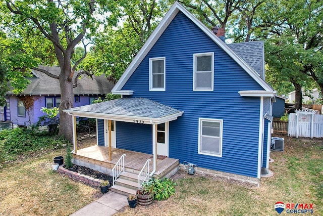 view of front facade with central AC, a front lawn, and a porch