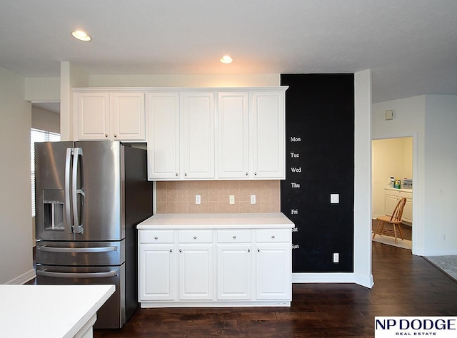 kitchen featuring white cabinetry, backsplash, stainless steel fridge, and dark hardwood / wood-style flooring