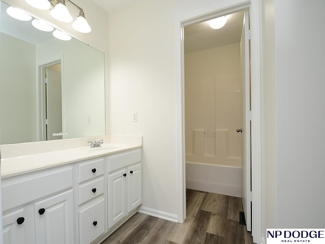 bathroom with a textured ceiling, vanity, and hardwood / wood-style flooring