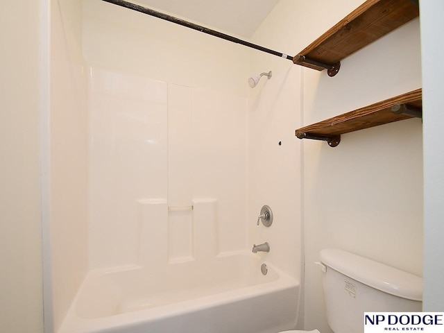 bathroom with washtub / shower combination and toilet