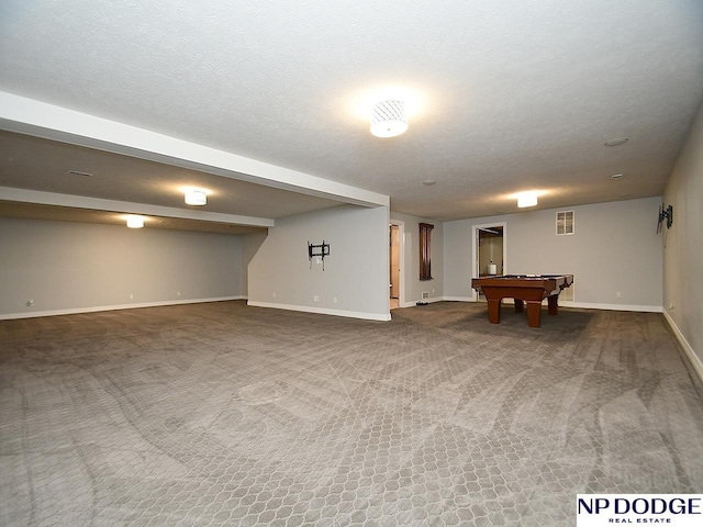 basement featuring a textured ceiling, carpet floors, and pool table