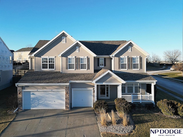 view of front of house featuring a porch and a garage