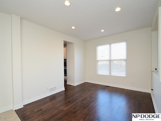 unfurnished room featuring dark hardwood / wood-style flooring