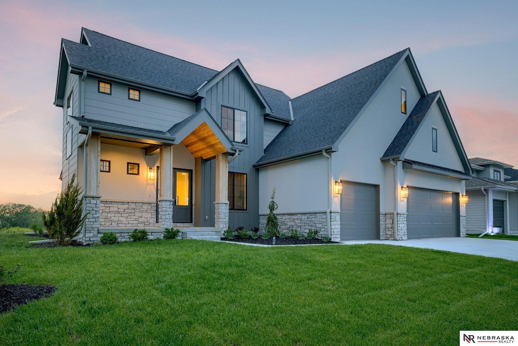 view of front of property with a lawn and a garage