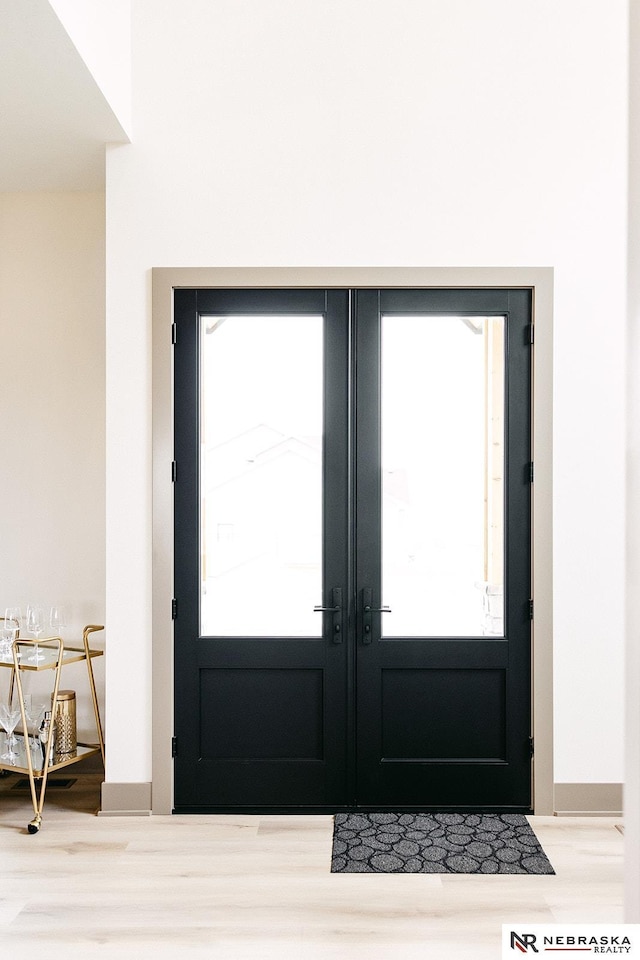 doorway to outside featuring french doors and a healthy amount of sunlight