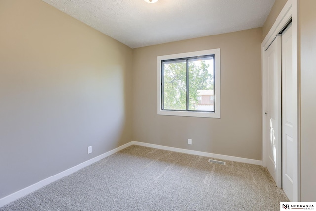 unfurnished bedroom featuring a closet and carpet