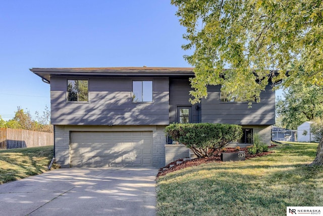 split foyer home with a front lawn and a garage