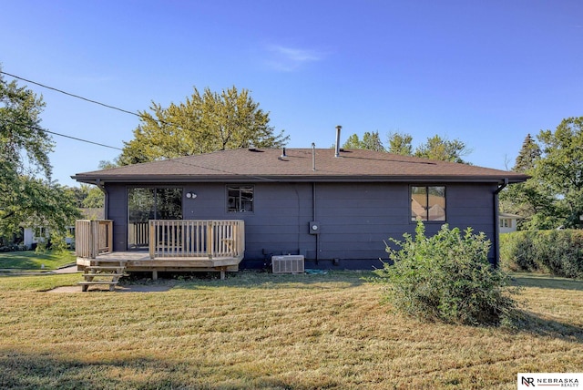 back of house featuring a yard, a wooden deck, and central AC