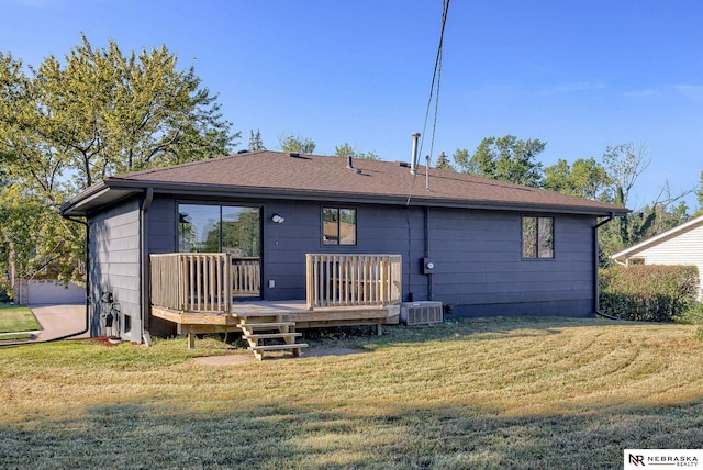 rear view of house with a lawn, central air condition unit, and a wooden deck