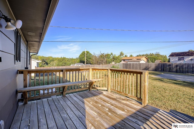 wooden terrace with a lawn