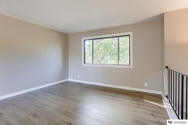 unfurnished room featuring light hardwood / wood-style floors