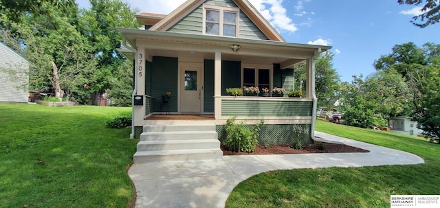 bungalow-style house with covered porch and a front yard