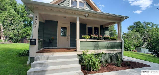 view of front of house with covered porch and a front yard