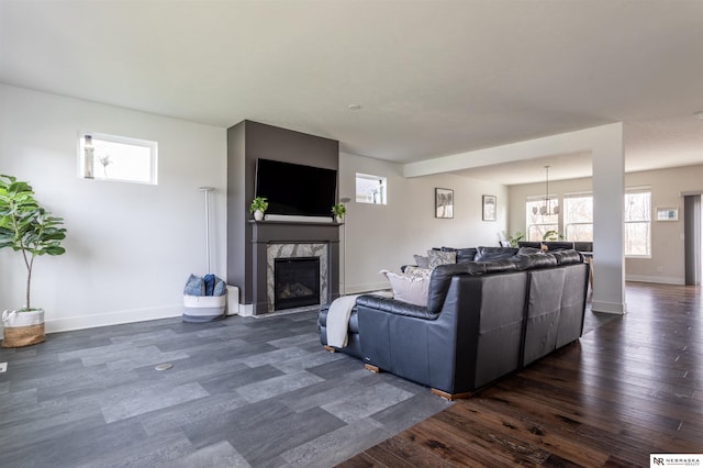 living room with dark hardwood / wood-style flooring and a high end fireplace