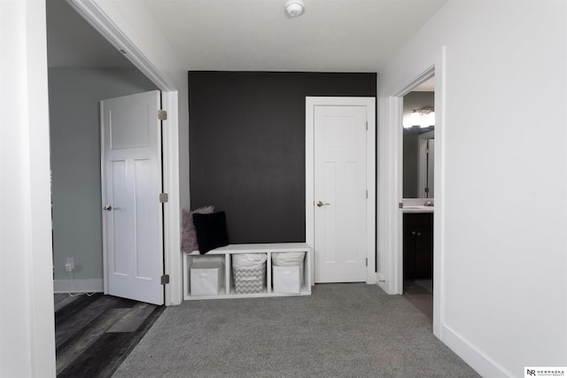 interior space featuring dark colored carpet and ensuite bath