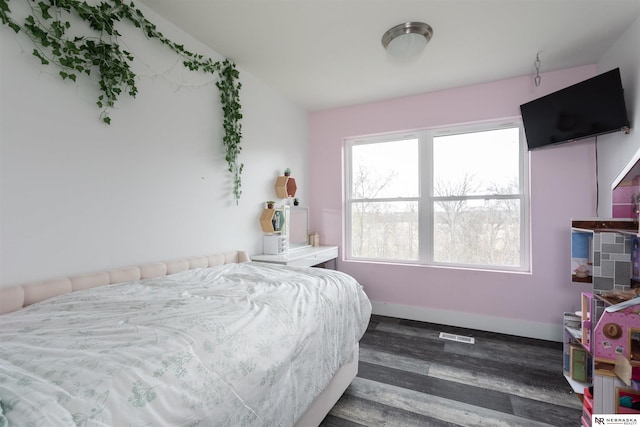 bedroom with wood-type flooring and vaulted ceiling