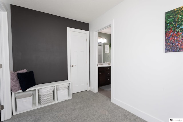 unfurnished bedroom featuring carpet floors and ensuite bath