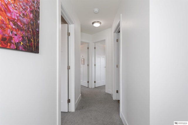 hall with light colored carpet