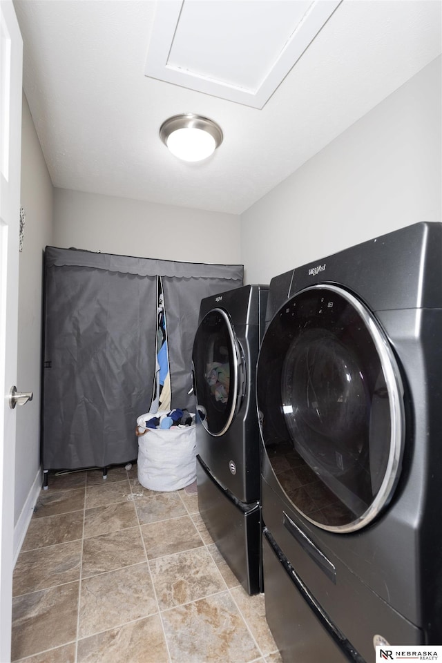 washroom with washing machine and clothes dryer