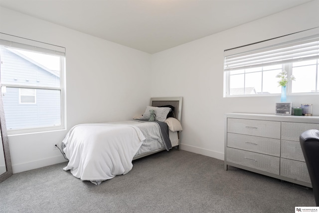 carpeted bedroom featuring multiple windows