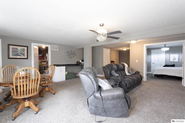 carpeted living room featuring ceiling fan