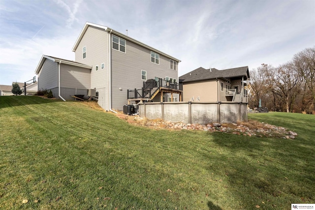 back of property featuring central air condition unit, a lawn, and a pool side deck